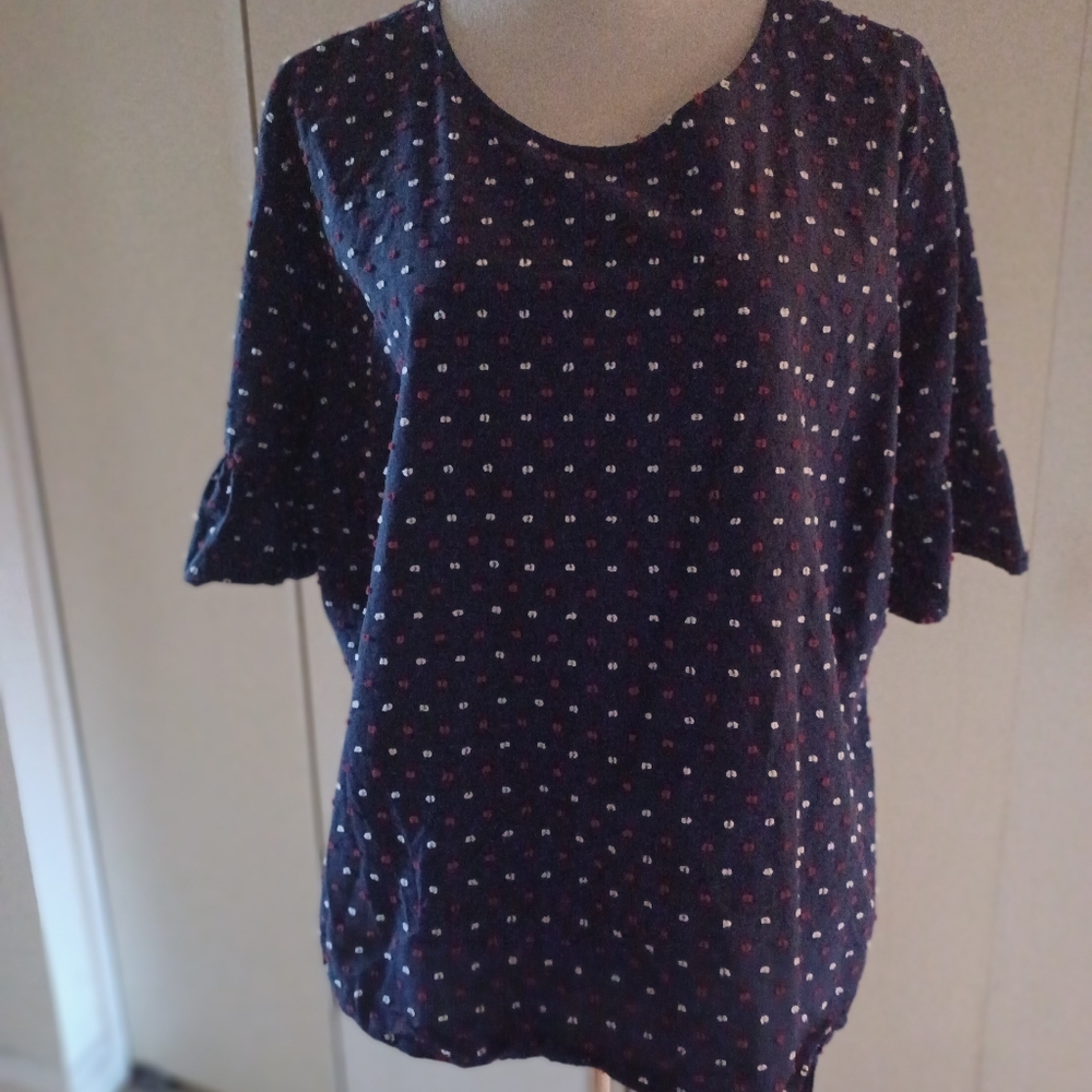 Blue blouse with red and white dot stitched in details. Buttons are on the back.